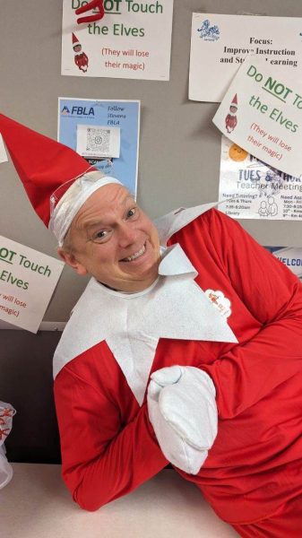 Mr. Guymon dressed as the Elf on the Shelf to bring holiday cheer to the students.