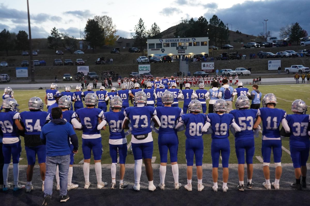 The varsity team lined up as the captains heade out for the final coin toss of the season.